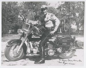 Primary view of object titled '[Abilene Police Officer Bryan Wason on a Motorcycle]'.