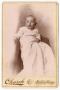 Photograph: [Unknown Baby in Long Fabric Clothing]