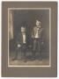 Photograph: [Two Young Boys Wearing Dark Clothing]