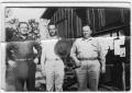 Primary view of [Three men pose by the CCC camp bulletin board]