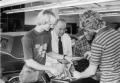Photograph: [Auto mechanics students working with Roy McCormick.
