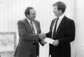 Photograph: [Hardy White (L) of GTE presents a check to Randy Busch.]