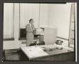 Photograph: [Lafayette B. Williams at Filing Cabinet]