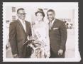 Photograph: [Miss KNOK 1964 With Two Men]