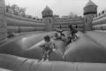 Photograph: [Children Playing in Inflatable Bounce House]