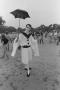 Photograph: [Man in Costume Holding an Umbrella]
