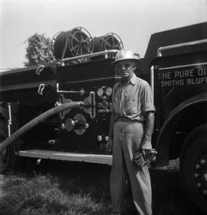 Primary view of object titled '[Man in Front of Fire Engine]'.