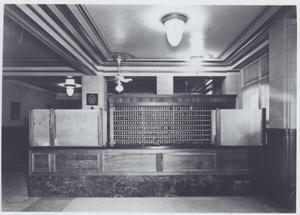Primary view of object titled '[Registration desk of the Stephen F. Austin Hotel]'.