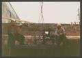 Photograph: [Construction Workers on Metal Tank]