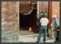 Photograph: [Construction Workers Placing Metal Tank]