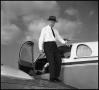 Photograph: [Gentleman Exiting Small Aircraft]