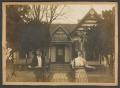 Photograph: [Photograph of William and Willie Harper in Front of Their Home]