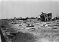 Photograph: [Damaged Homes and Debris]