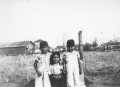 Photograph: [Photograph of three children in front of a pasture]