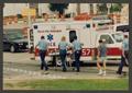 Photograph: [Paramedics Moving a Gurney to an Ambulance]