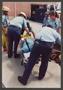 Primary view of [Paramedics Loading Firefighter on Gurney]