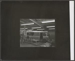 Primary view of object titled '[Bus Parked in a Garage]'.