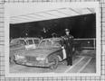 Photograph: [Photograph of Lee Brown Next to a Police Vehicle]