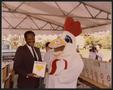Photograph: [Photograph of Lee Brown and Ernie the Safeway Super Chicken]