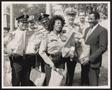 Photograph: [Lee Brown and Several Police Officers Carrying Kroger Bags]