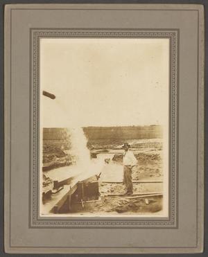 Primary view of object titled '[Man Standing Near Water Pipe]'.