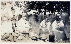 Primary view of object titled '[Women cooking over campfire]'.