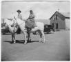 Photograph: Mr. and Mrs. E.L. Jones on horseback