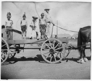 Primary view of object titled 'Allen Hall on wagon with children dressed as Indians'.