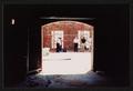Photograph: [View of Construction Scaffolding Through Arched Doorway]