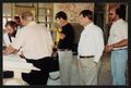 Photograph: [Group Reviewing Plans at Construction Site]