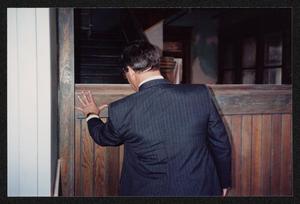 Primary view of object titled '[Back Shot of a Man With His Hand on The Staircase in The Dr. Pepper Museum]'.