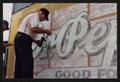 Thumbnail image of item number 1 in: '[Close-Up of Artists Restoring Dr. Pepper Mural]'.