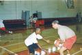 Photograph: Head basketball coach, Roy Champagne, with basketball camp for boys