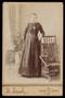 Photograph: [An Unidentified Woman Posing with a Rocking Chair]