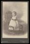Photograph: [Portrait of a Child Standing on a Wicker Chair]