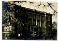 Primary view of [College of Marshall Main Building Viewed through Tree Branches]