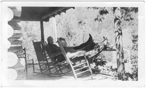 Primary view of object titled '[Col. Hugh B. and Helen Moore relaxing on the porch of their ranch]'.