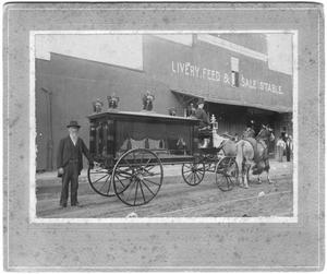 Primary view of object titled 'J.P. Crouch with Hearse, at C. R. Ritenour, Livery, Feed & Sale Store'.