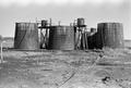 Thumbnail image of item number 1 in: '[Wooden Oil Tanks at Ada Belle Oil Field #2]'.