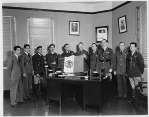 Primary view of object titled '[American and Mexican Air Force Officials Holding Mexican Air Force Flag]'.