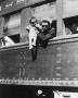 Photograph: [Emzie Fisher  on Train Holding His Son During World War II]