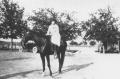 Photograph: [Woman in a Field on a Horse]
