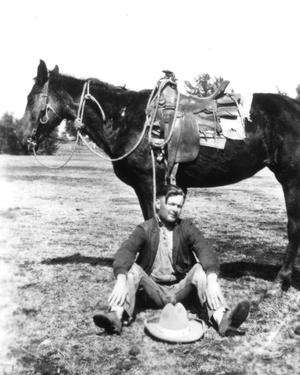Primary view of object titled '[Bethel Baker Sitting with a Saddled Horse]'.