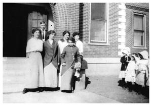 Primary view of object titled '[Teachers Standing Outside a School Building]'.