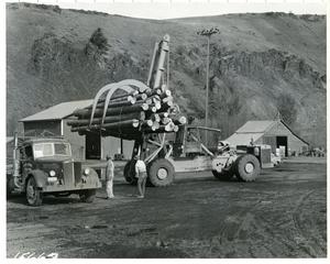 Primary view of object titled 'Log stacker handling a bunch of logs, J5G, Photo 26, L-15667'.