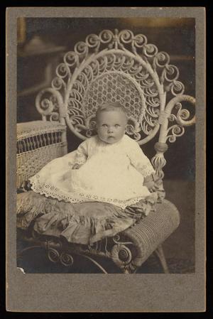Primary view of object titled '[Portrait of a Baby in a Cushioned Wicker Chair]'.