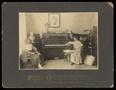 Photograph: [Women with a Thos. Goggan & Bros Piano]
