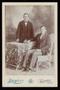 Photograph: [Portrait of Two Unknown Men and a Wicker Chair]