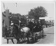 Photograph: [Fleet Admiral Chester W. Nimitz Waves from Horse Drawn Carriage]