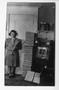 Primary view of [Photo of Cecelia Mckie Standing Next to Her Scrapbooks]